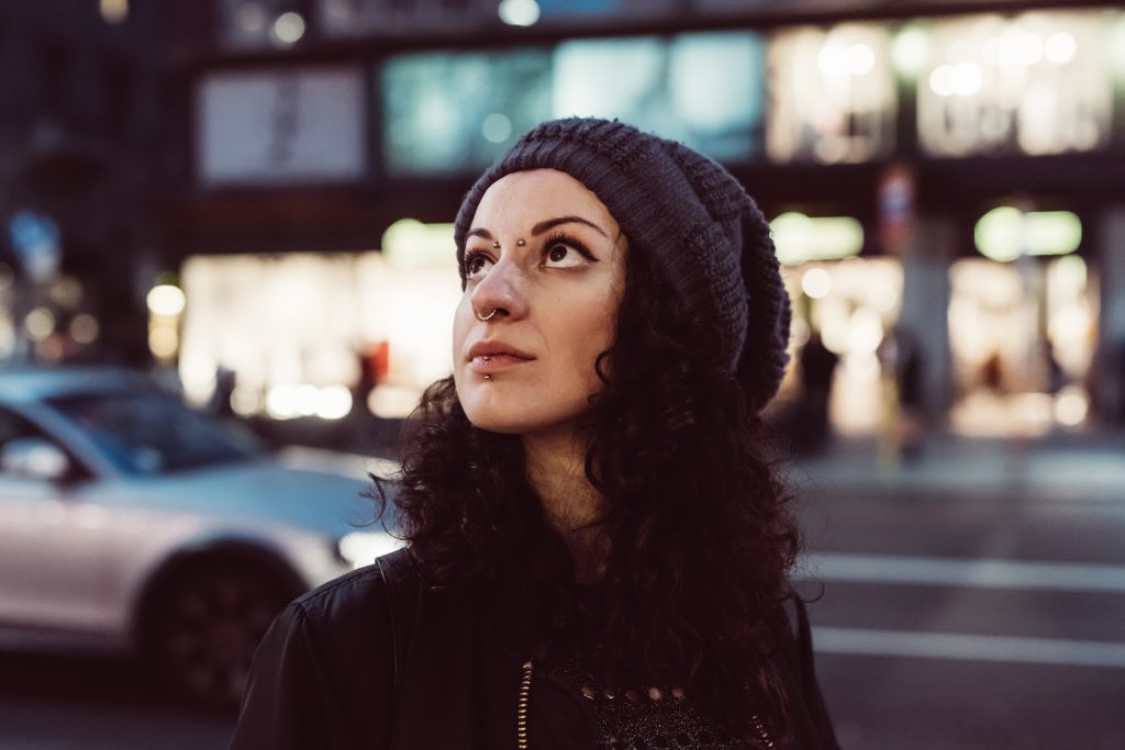 Young pierced woman overlooking night